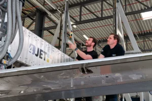 Two 4JET engineers working on an aircraft wing