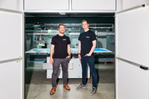 Portrait of two 4JET engineers in front of the laser system
