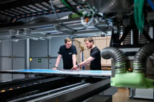 Two 4JET engineers working at the laser workstation