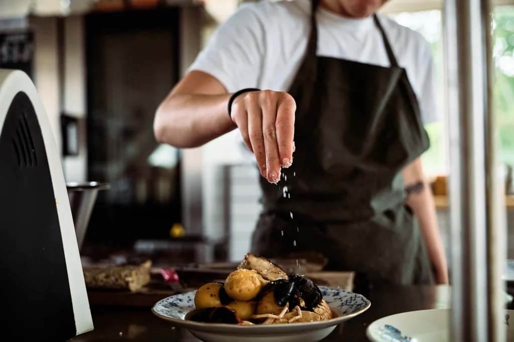 A chef adding the finishing touches to a plate