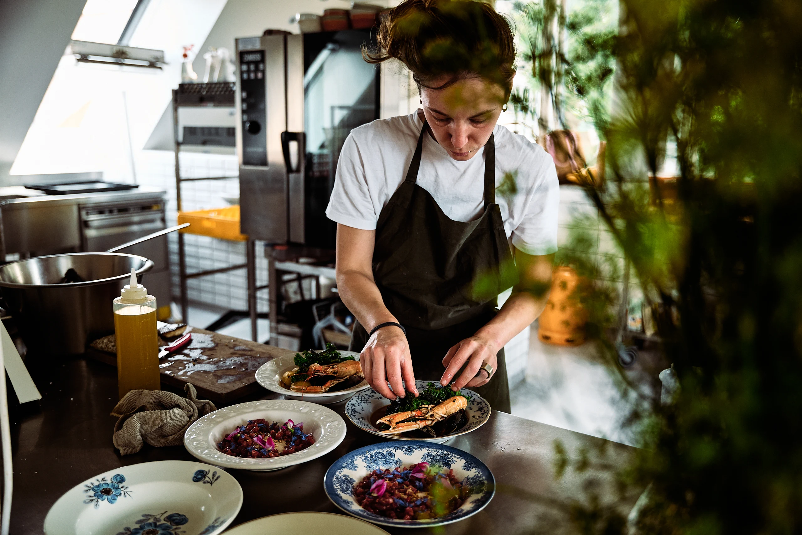 A chef serving dishes at an outdoor table