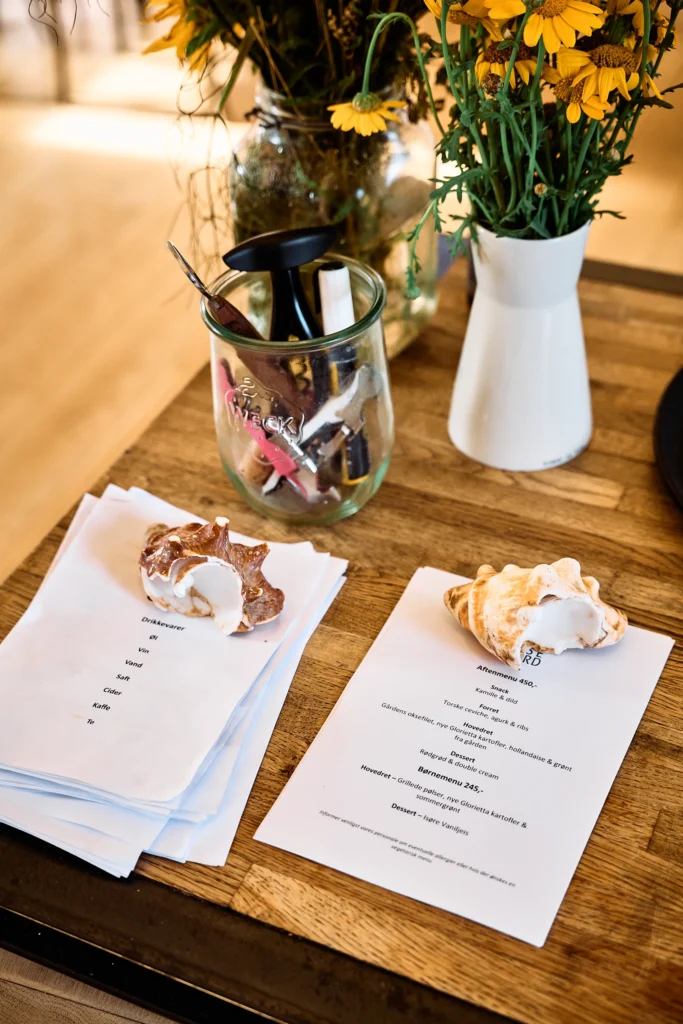 Menu and flowers on a dining table at Birkemosegaard