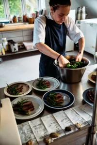 A chef plating several seasonal dishes