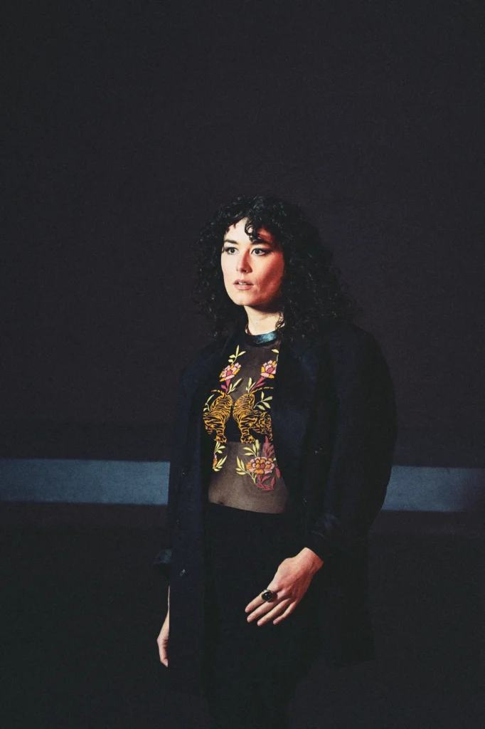 Portrait of soprano Marie Heeschen of Ensemble BRuCH against the dark interior of St. Peter Cologne