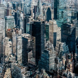 Abstract multilayer photograph of Manhattan architecture, combining overlapping urban structures, movement and light into a dense geometric composition.