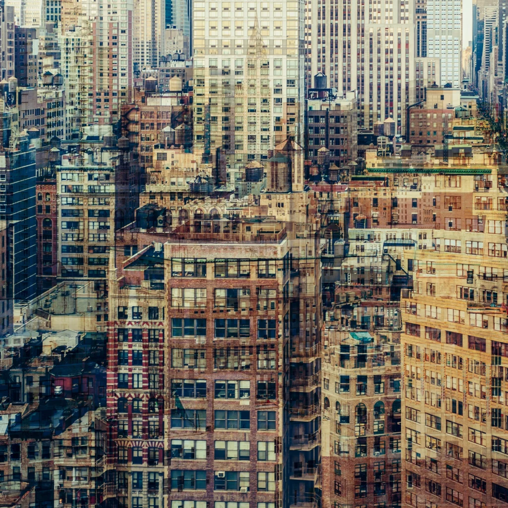 Abstract multilayer photograph of Manhattan architecture, combining overlapping urban structures, movement and light into a dense geometric composition.