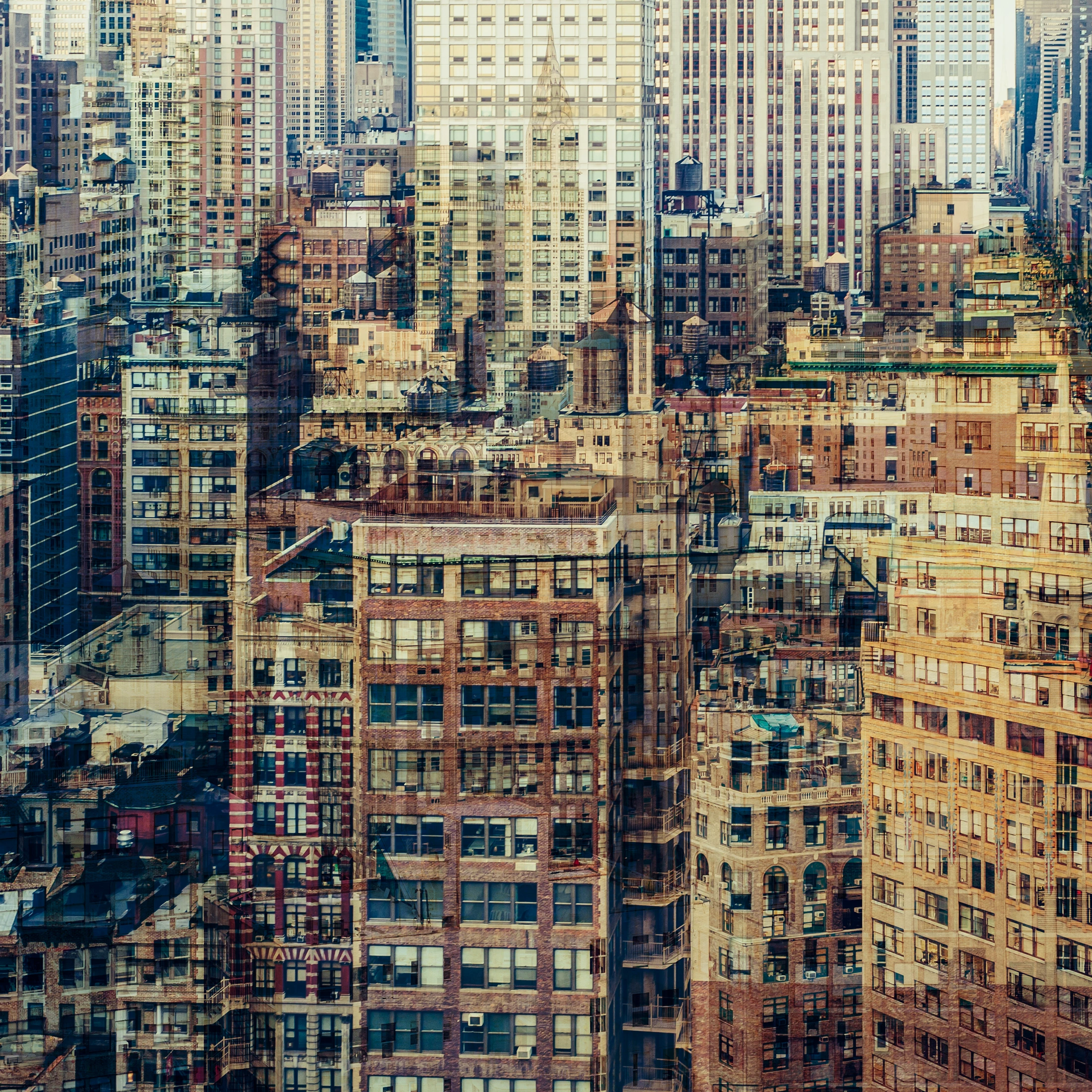 Abstract multilayer photograph of Manhattan architecture, combining overlapping urban structures, movement and light into a dense geometric composition.