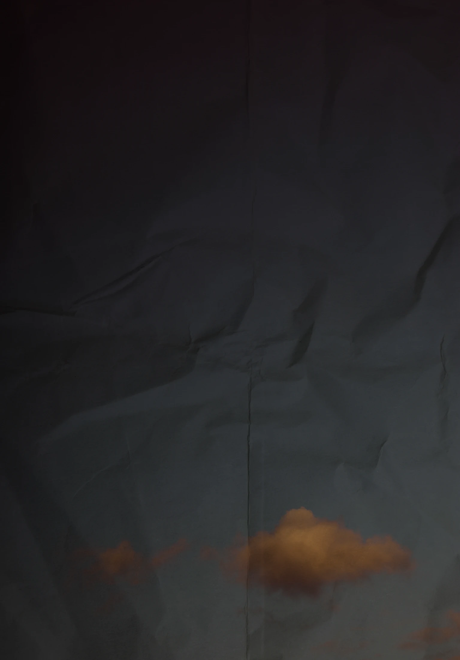 Double layer photography of sky with clouds and crumpled paper.